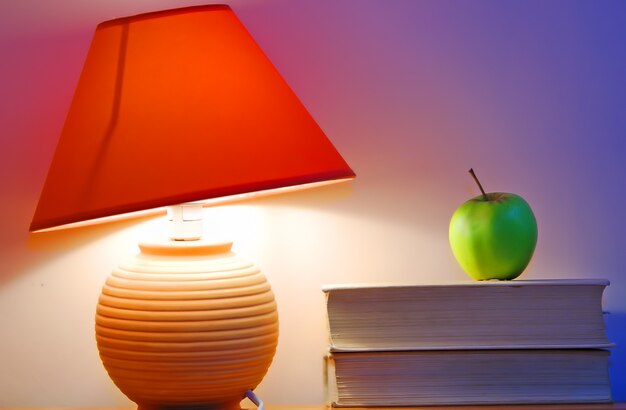 Desk lamp and an apple