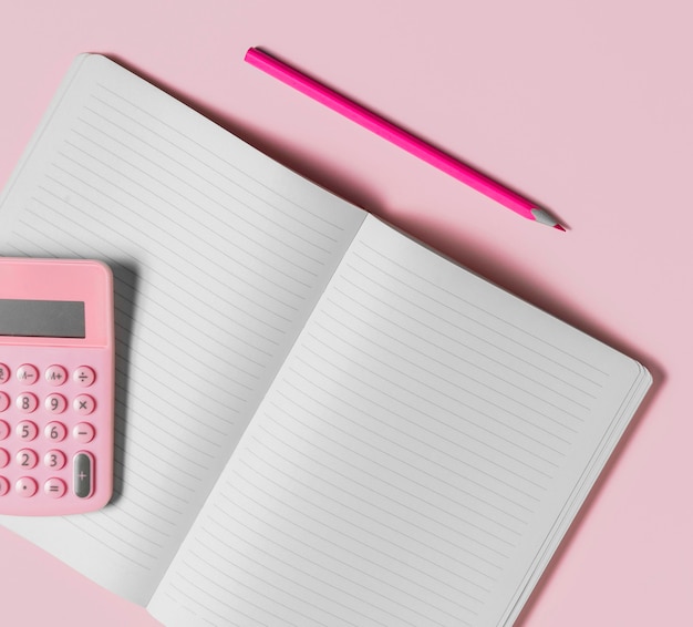 Desk minimal blank notebook and pink calculator