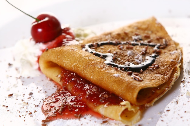 Dessert plate with pancakes and cherries