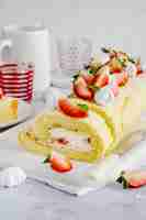 Free photo dessert and tea with strawberry swiss roll food photography