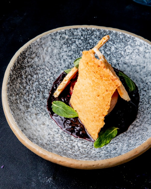 Dessert with ice- cream in a bowl jam mint side view