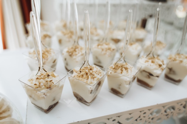 Desserts in the portion molds stand on the catering table