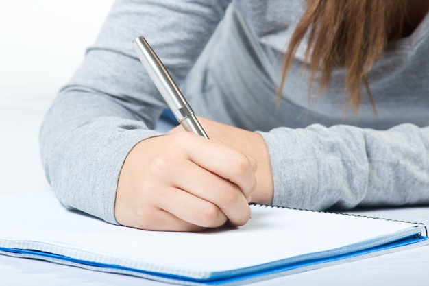 Detail of Beautiful young woman writting