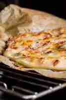 Free photo detail of homemade pizza on oven grate