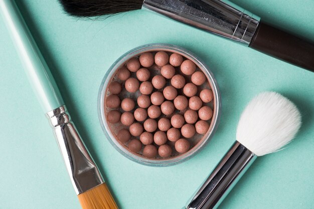 Detail of makeup brush with bronzed pearls