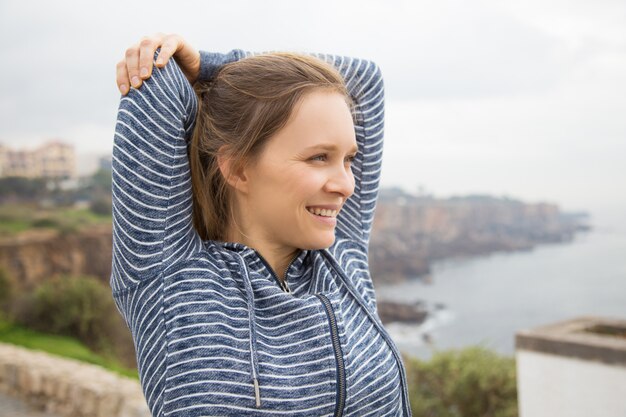 Determined attractive woman practicing exercise for arms