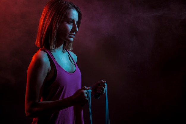 Determined woman with elastic rope