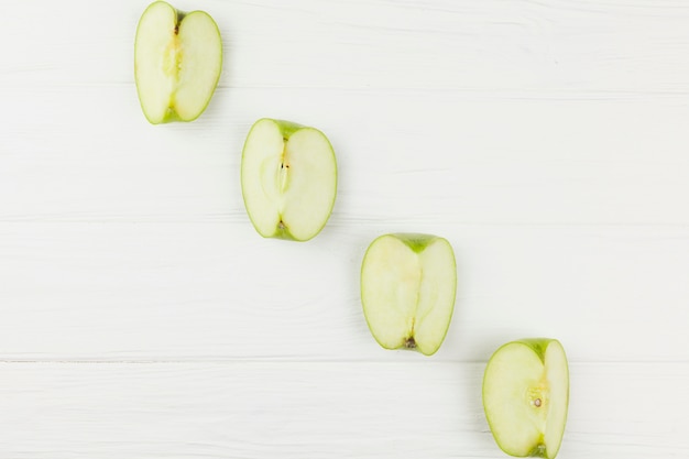 Diagonal of apples slices on white background