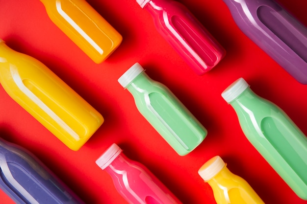 Diagonally colorful smoothies on red background