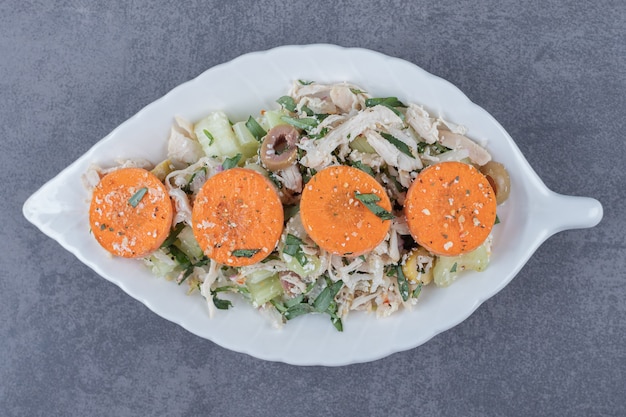 Diced chicken salad on leaf-shaped plate.