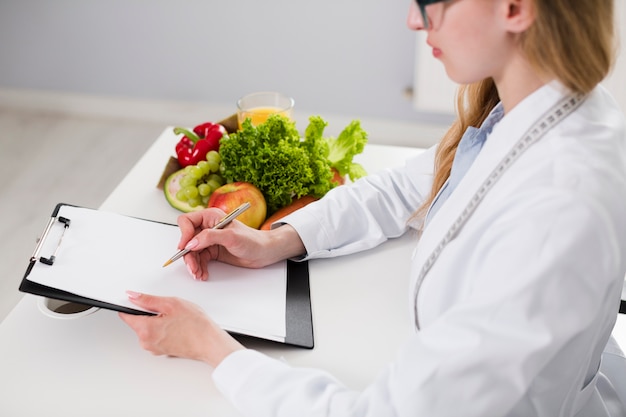 Free Photo diet concept with female scientist and healthy food