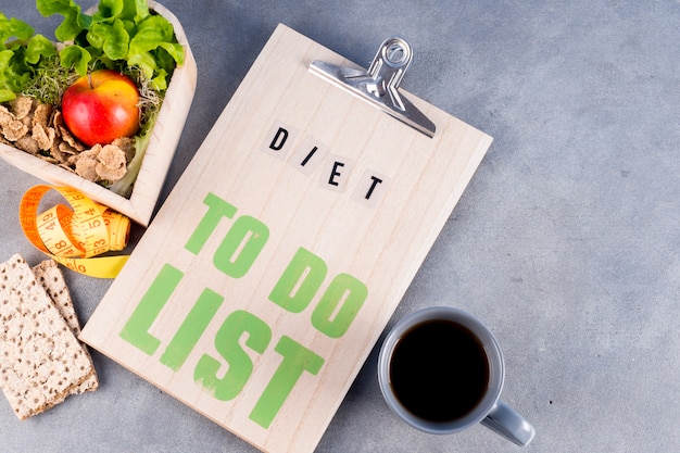 Free photo diet to do list with healthy food and drink on table