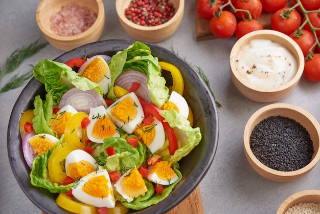 Free Photo diet menu. healthy salad of fresh vegetables tomatoes, egg, onion. healthy meal concept.