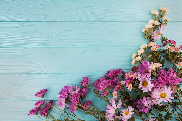 Different bright flowers scattered on table