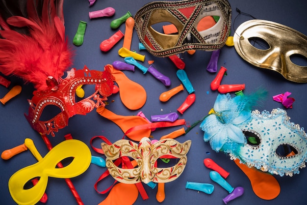 Different carnival masks on blue background