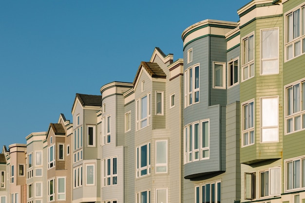 Free Photo different color apartments near each other with a clear sky