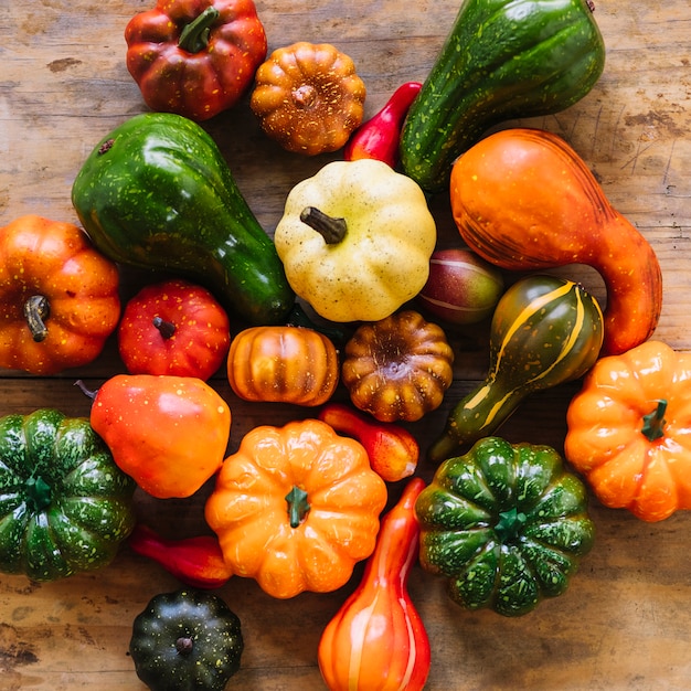 Different color pumpkins on desk 