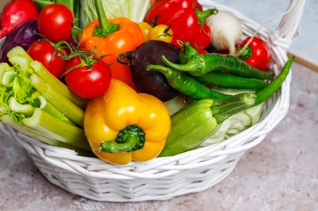 Different colorful fresh vegetables on concrete surface