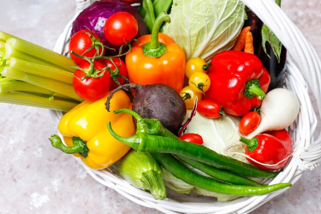 Different colorful fresh vegetables on concrete surface