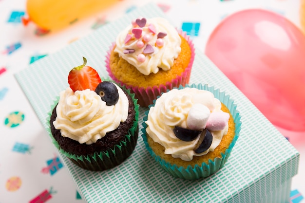 Free Photo different cupcakes with berries on box