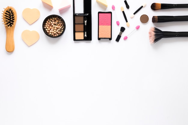 Different facial powders with powder brushes on light table