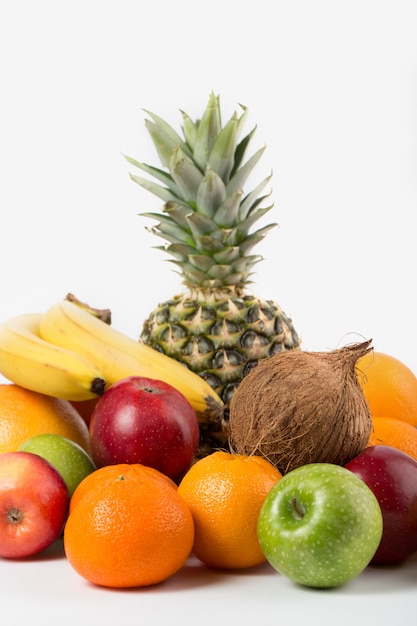 Different fruits ripe juicy whole isolated on a white floor