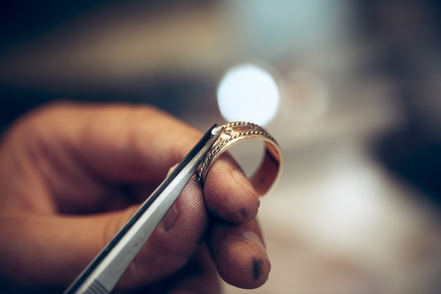 Different goldsmiths tools on the jewelry workplace. Jeweler at work in jewelry.