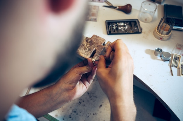 Different goldsmiths tools on the jewelry workplace. Jeweler at work in jewelry.