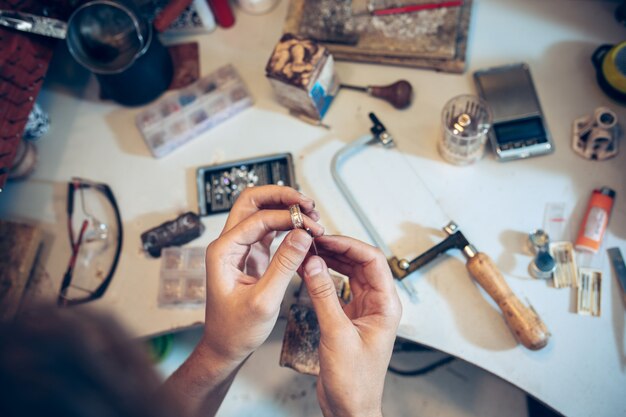 Different goldsmiths tools on the jewelry workplace. Jeweler at work in jewelry.