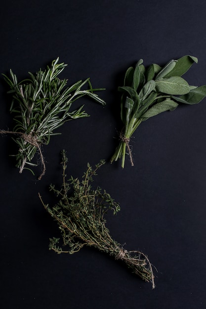 Free photo different herbs in black table, top view