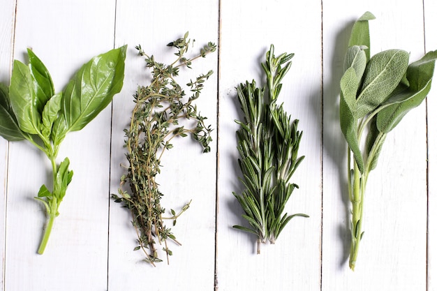 Free photo different herbs in white wooden table, top view