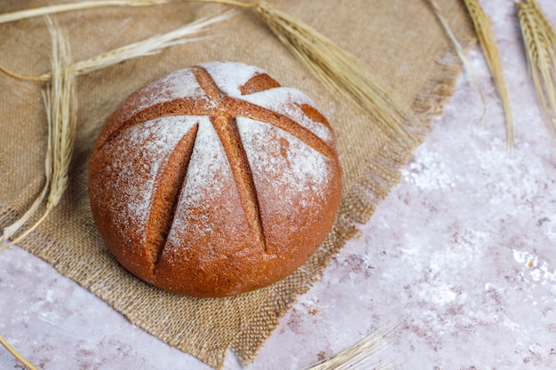 Different kinds of fresh bread as background, top view