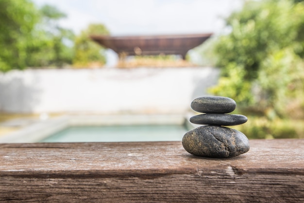 Free photo different pebbles are standing successively near the pool