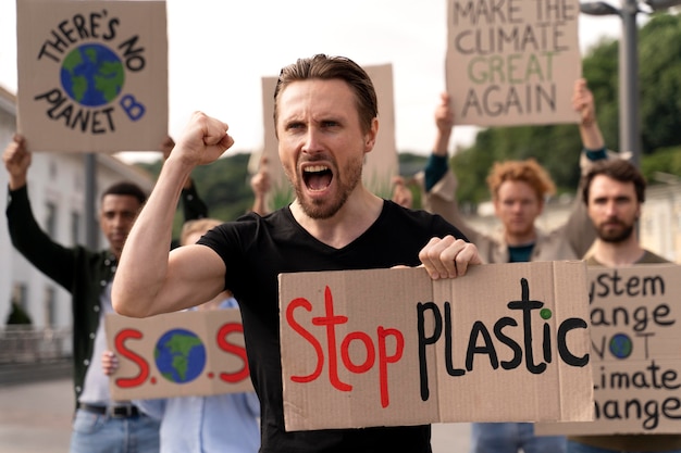 Free photo different people joining a global warming protest