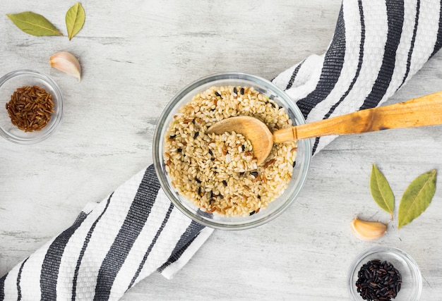 Free Photo different rice types in bowls with spoon on light table