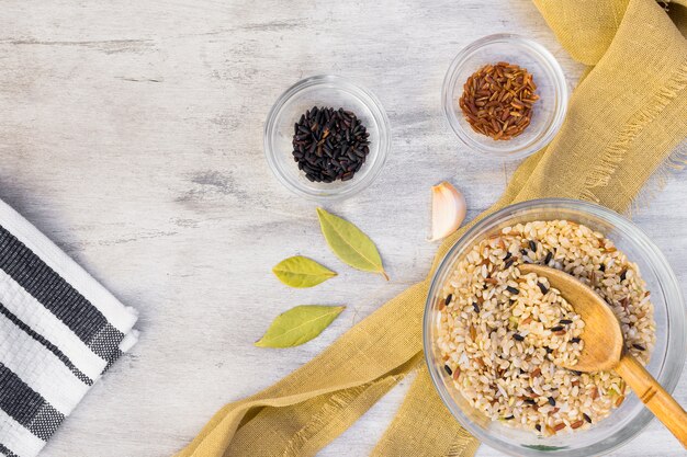 Different rice types in glass bowls on light table