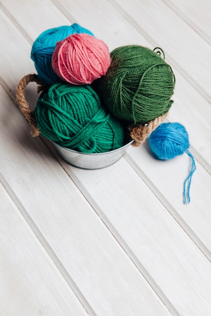 Different sized wool balls in pot