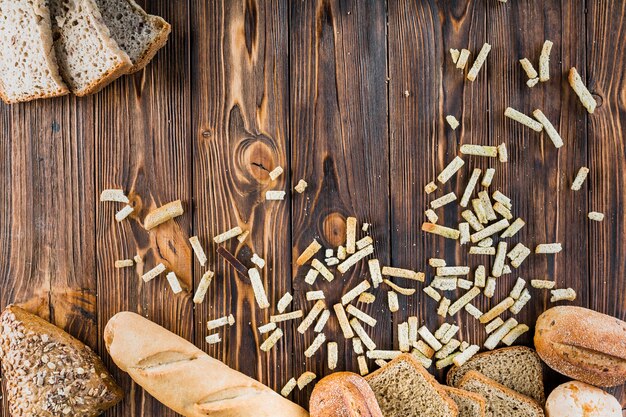 Different type of baked breads on wooden table