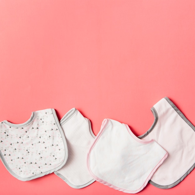 Different type of bibs on peach backdrop