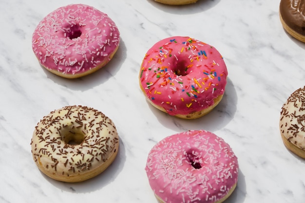 Free photo different type of donuts on marble textured backdrop