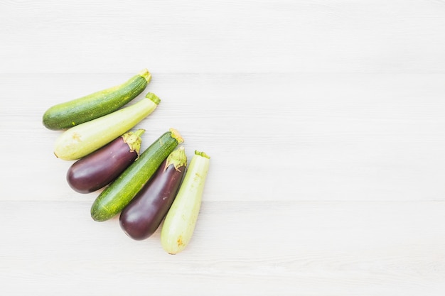 Free photo different type of eggplants on wooden background