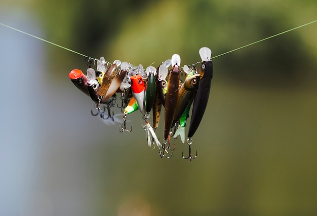 Free photo different type of fish lure hanging on fishing line