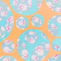 Free photo different type of geometric circles over the floral wallpaper