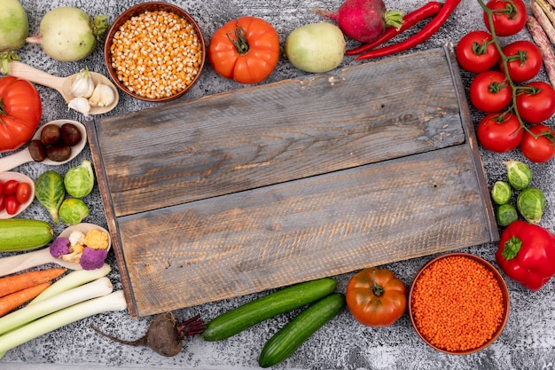 Different type of vegetables around the wood cutting board