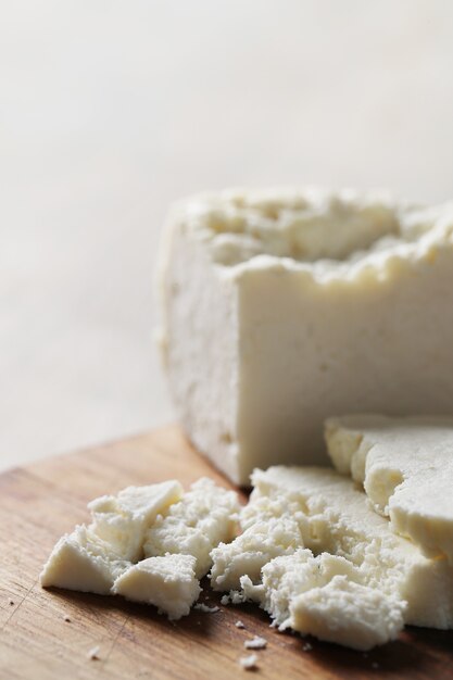 Different types of cheese on cutting board