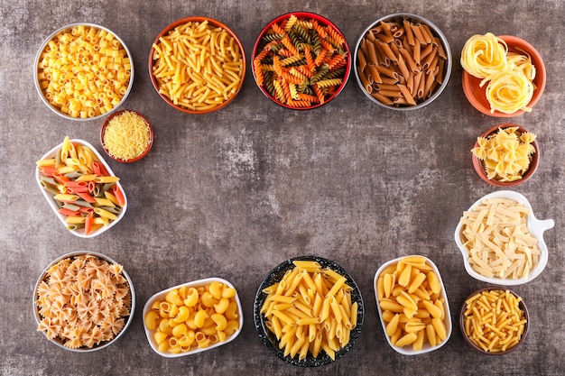 different types of pasta in different plates top view