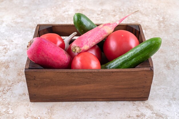 Free photo different vegetables in a box, on the marble table.