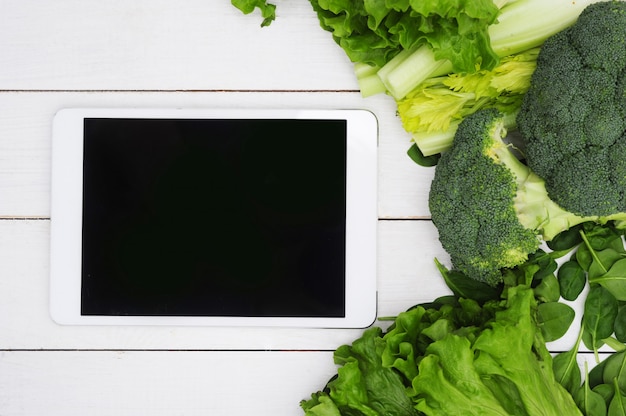 Digital tablet with black screen and vegetables, healthy food concept