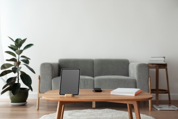 Free Photo digital tablet with blank black screen on a wooden table