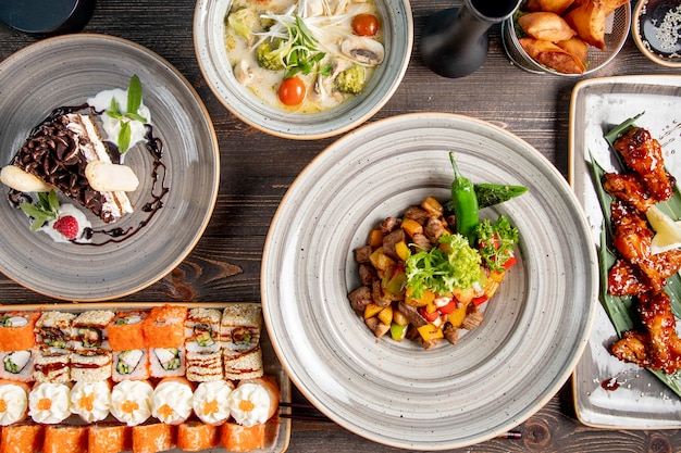 Dinner set with sushi soup fried chicken meat with potatoes and cake